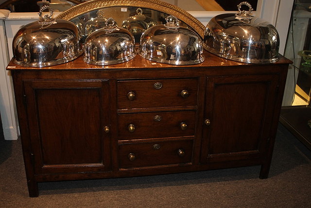 Appraisal: A GEORGE III OAK DRESSER BASE front fitted three central