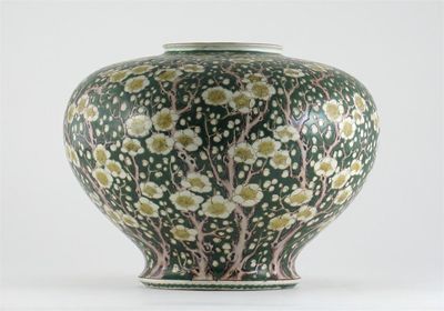 Appraisal: A Japanese compressed circular vase decorated with prunus on a