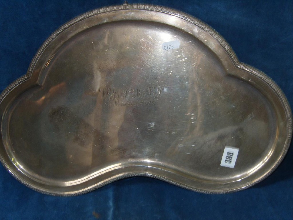 Appraisal: A shaped silver salver of stylised form with gadroon border