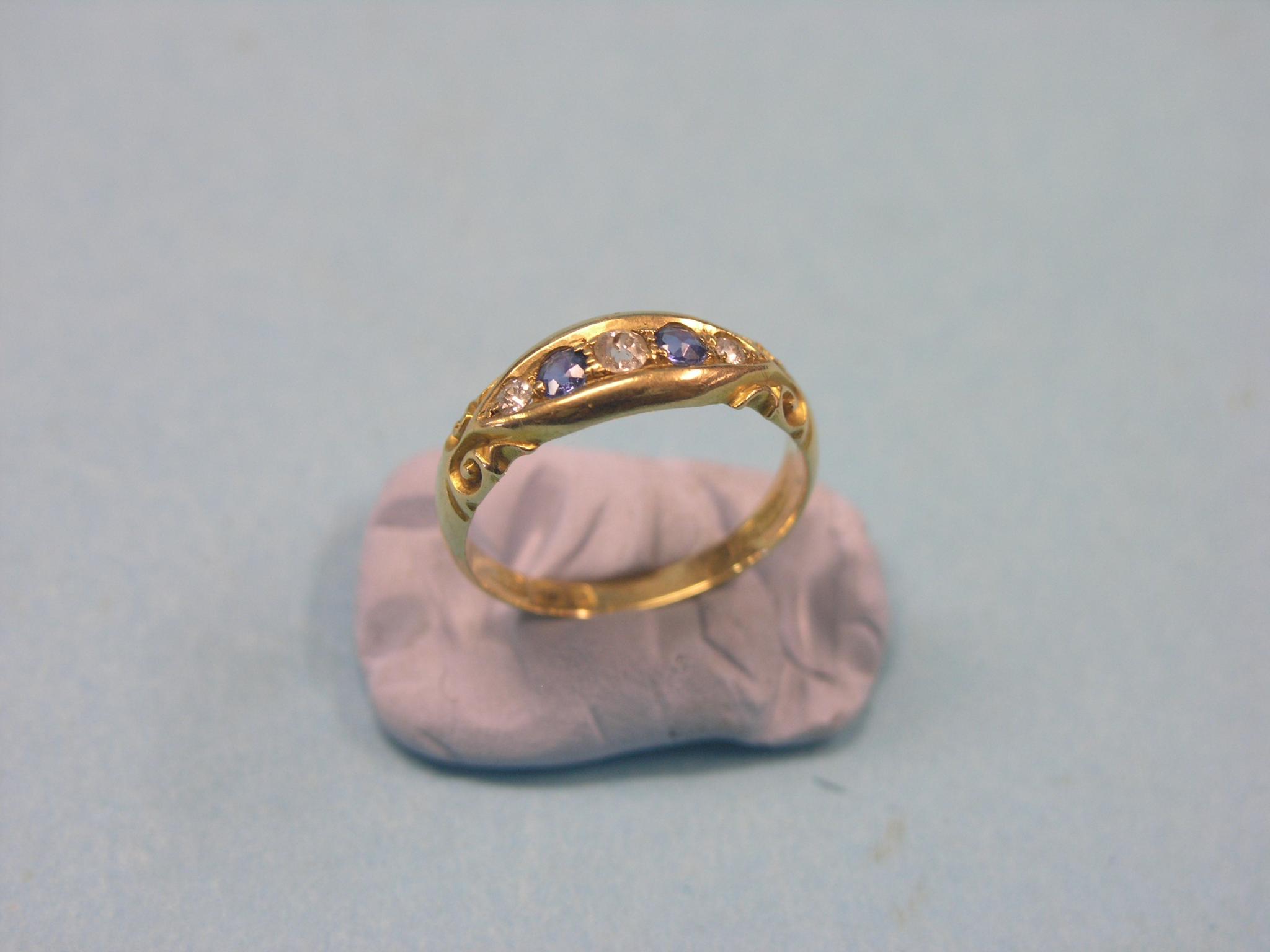 Appraisal: An ct gold half-hoop ring two pale sapphires and three