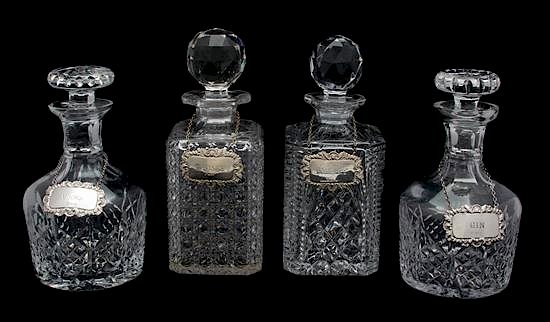 Appraisal: Four Cut Glass Decanters with English Silver Labels Height of