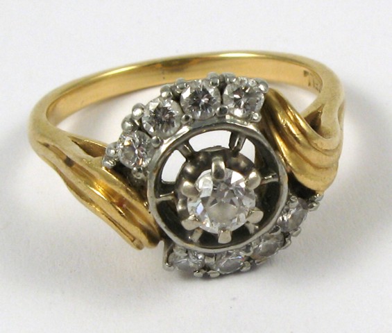 Appraisal: DIAMOND AND EIGHTEEN KARAT GOLD RING centering a round-cut diamond