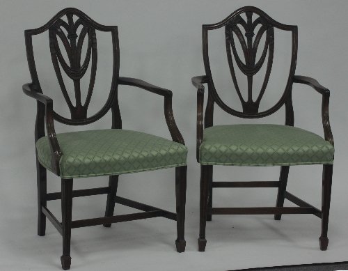 Appraisal: A pair of George III style shield back armchairs carved