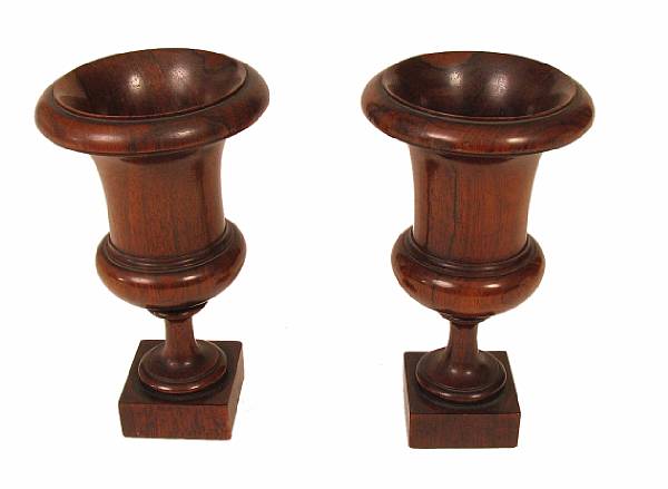 Appraisal: A pair of Neoclassical style lignum vitae urns height in