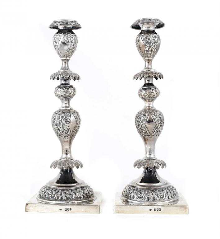 Appraisal: A PAIR OF VICTORIAN CANDLESTICKS the oviform sconce embossed with