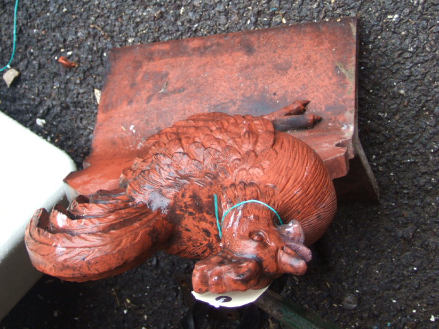 Appraisal: A terracotta roof finial ridge tile mounted with a cockerel