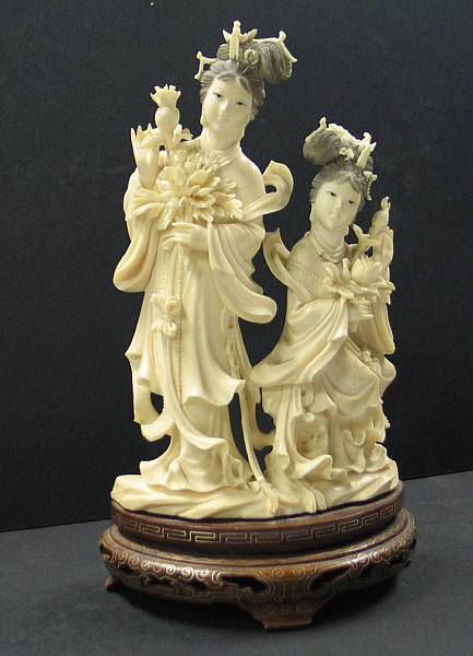 Appraisal: A tinted ivory carving of two beauties Depicting one seated