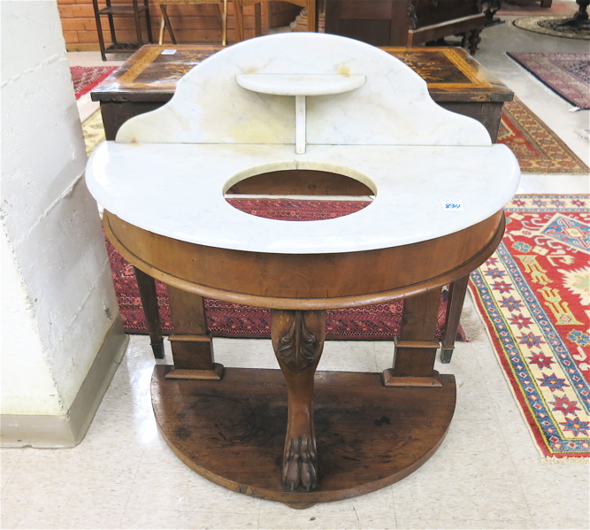 Appraisal: A VICTORIAN DEMILUNE MARBLE-TOP WASHSTAND English th century featuring a