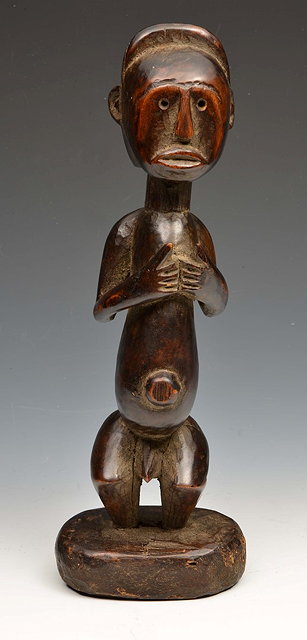 Appraisal: AN AFRICAN TRIBAL CARVED WOOD MALE FIGURE with clasped hands