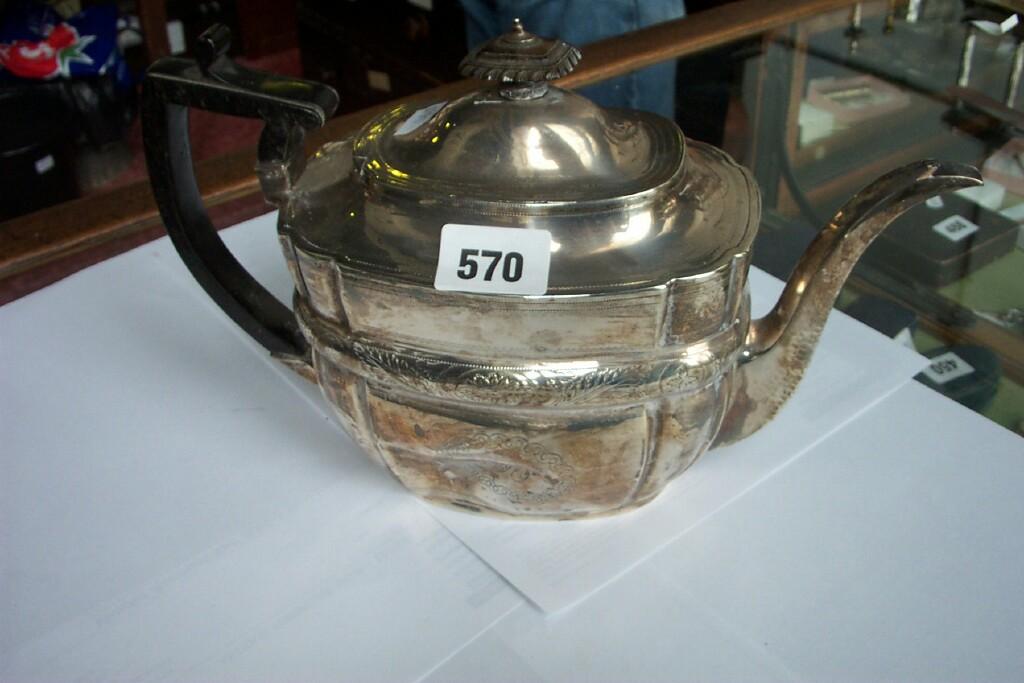 Appraisal: A Georgian silver teapot with engraved and chased decoration and