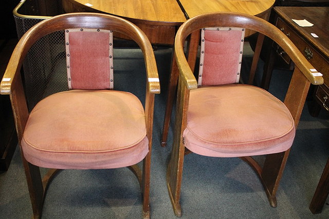 Appraisal: A PAIR OF ART DECO OAK TUB ARMCHAIRS with rounded