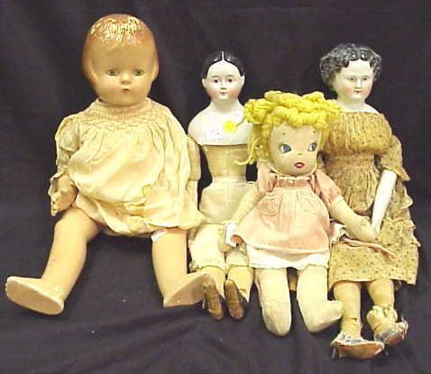 Appraisal: Four dolls two China head with black hair with firing