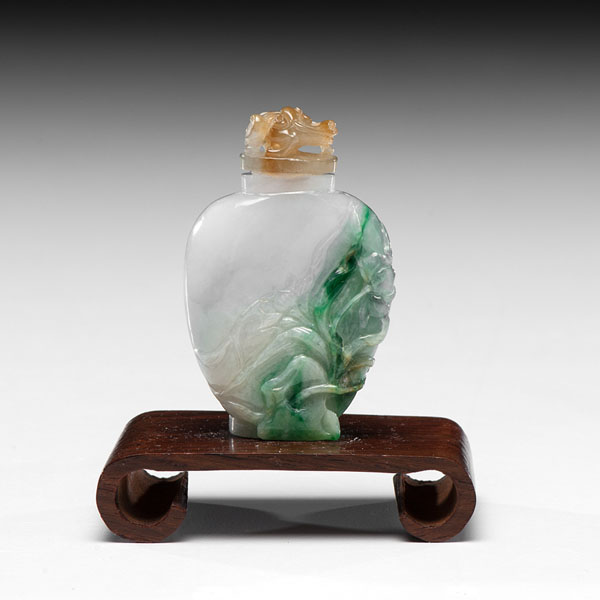 Appraisal: Chinese A white and green jadeite snuff bottle with relief