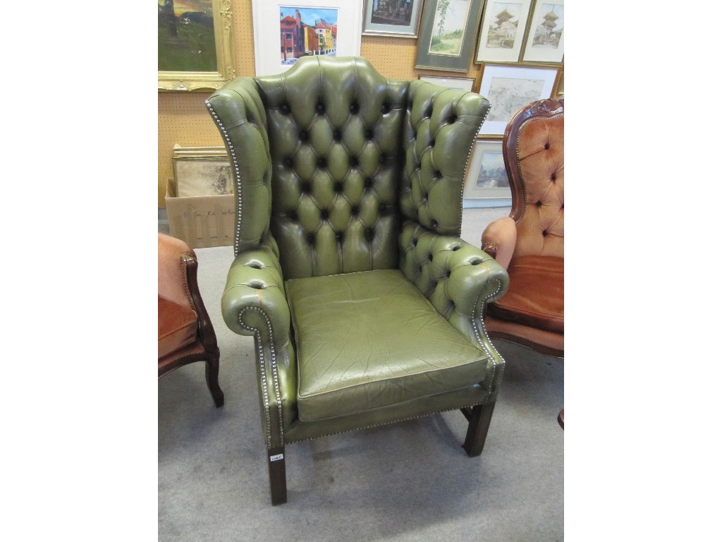 Appraisal: Green leather Chesterfield wing armchair