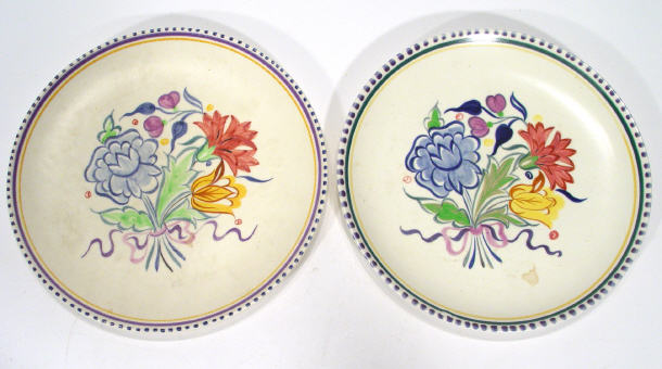 Appraisal: Two Poole Pottery traditional plates hand painted with flowers printed