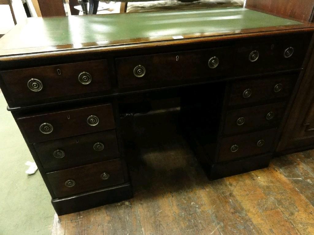 Appraisal: A Georgian style mahogany kneehole pedestal desk fitted with an