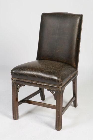 Appraisal: A GEORGE III STYLE UPHOLSTERED LIBRARY CHAIR the leather upholstered