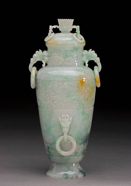 Appraisal: A mottled jadeite covered vase Carved in delicate relief with