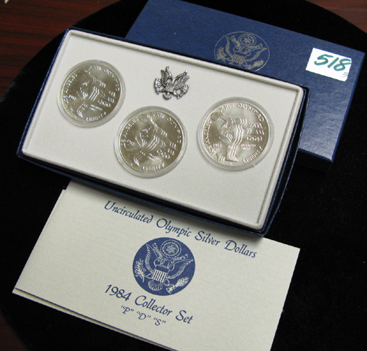 Appraisal: THREE CASED OLYMPIC COMMEMORATIVE MINT SETS and PDS three-coin silver