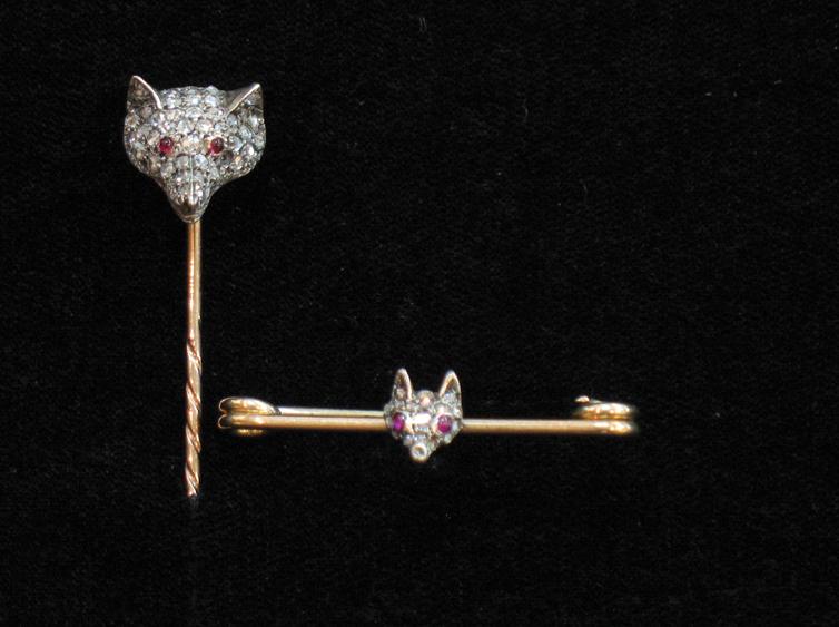 Appraisal: A FOXHEAD STICK PIN the terminal modelled as a foxes