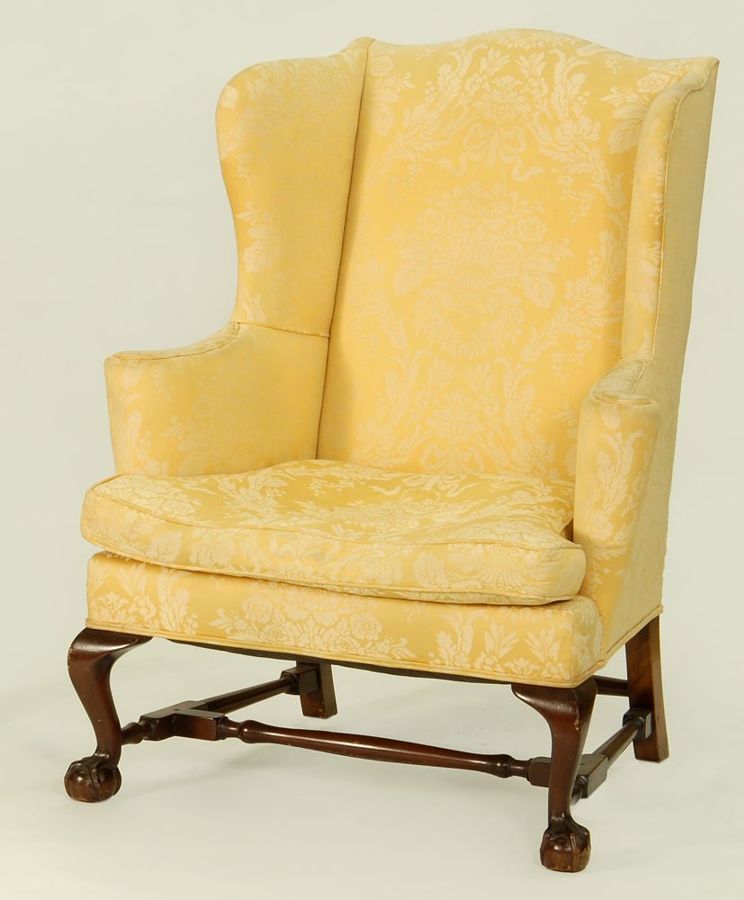 Appraisal: CENTENNIAL CHIPPENDALE-STYLE WING CHAIR With cyma-curve legs terminating in claw