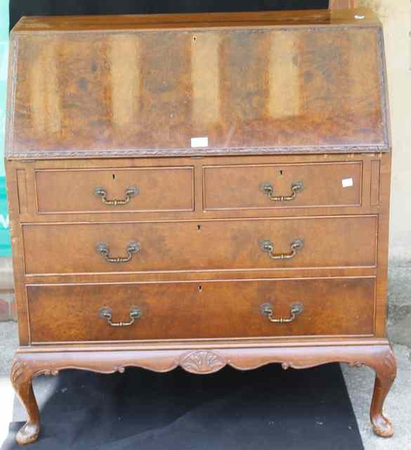 Appraisal: A WALNUT BUREAU the fall front enclosing a fitted interior