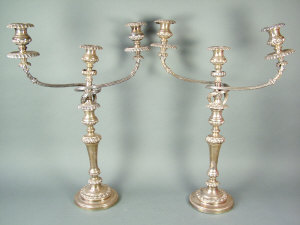 Appraisal: A pair of silver on copper plated twin branch candelabra