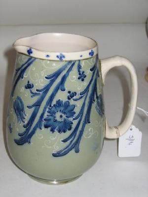 Appraisal: A MCINTYRE POTTERY JUG tube lined and painted with blue