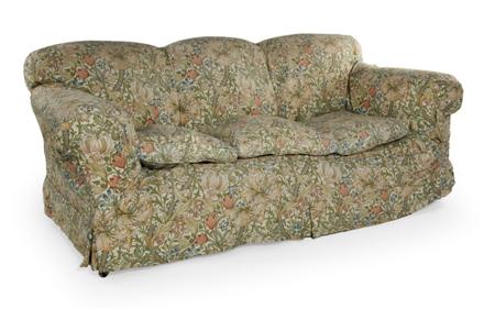 Appraisal: An Edwardian sofa the triple arched cushion back over scroll