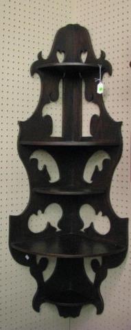 Appraisal: An antique walnut corner shelf with cut out design approximately