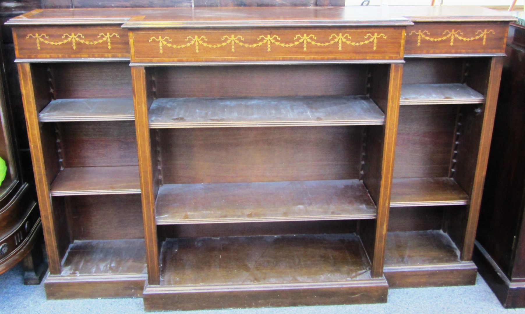 Appraisal: An inlaid Edwardian mahogany floor standing open breakfront bookcase cm