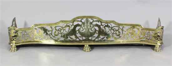 Appraisal: A late George III pierced brass serpentine fender decorated with