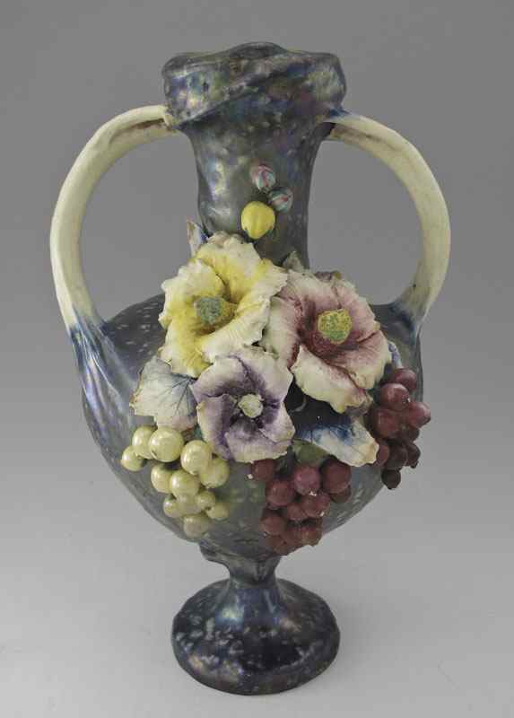 Appraisal: AMPHORA ART POTTERY HANDLED VASE Flowers and berries motif mottled