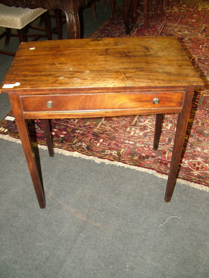 Appraisal: A George III mahogany side table with frieze drawer upon