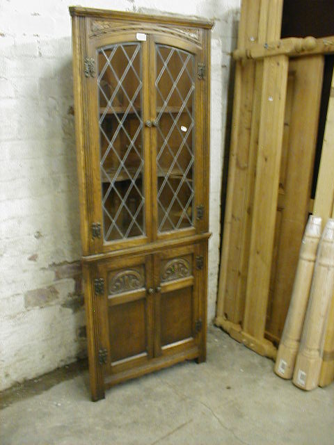 Appraisal: A leaded glazed oak corner cabinet