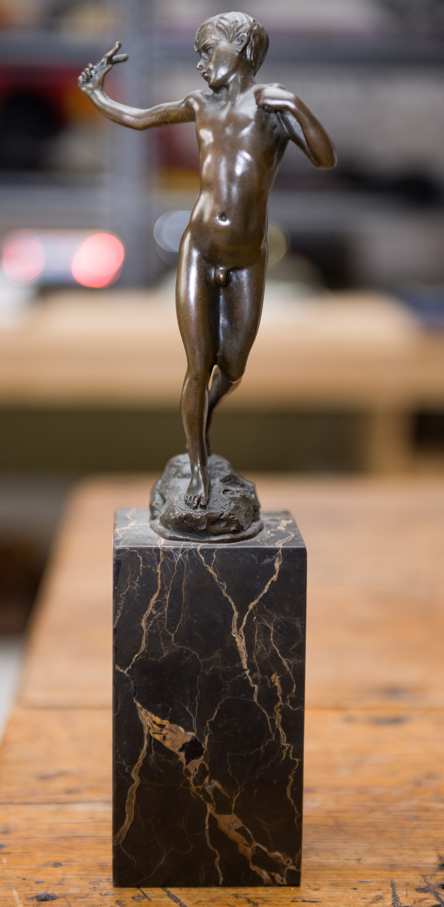 Appraisal: A BRONZE OF BOY WITH SLINGSHOT ON A MARBLE BASE