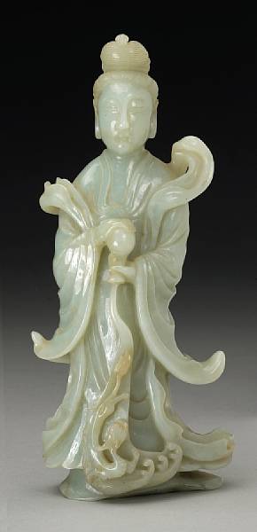 Appraisal: A pale gray-green jade standing Guanyin The figure depicted emptying