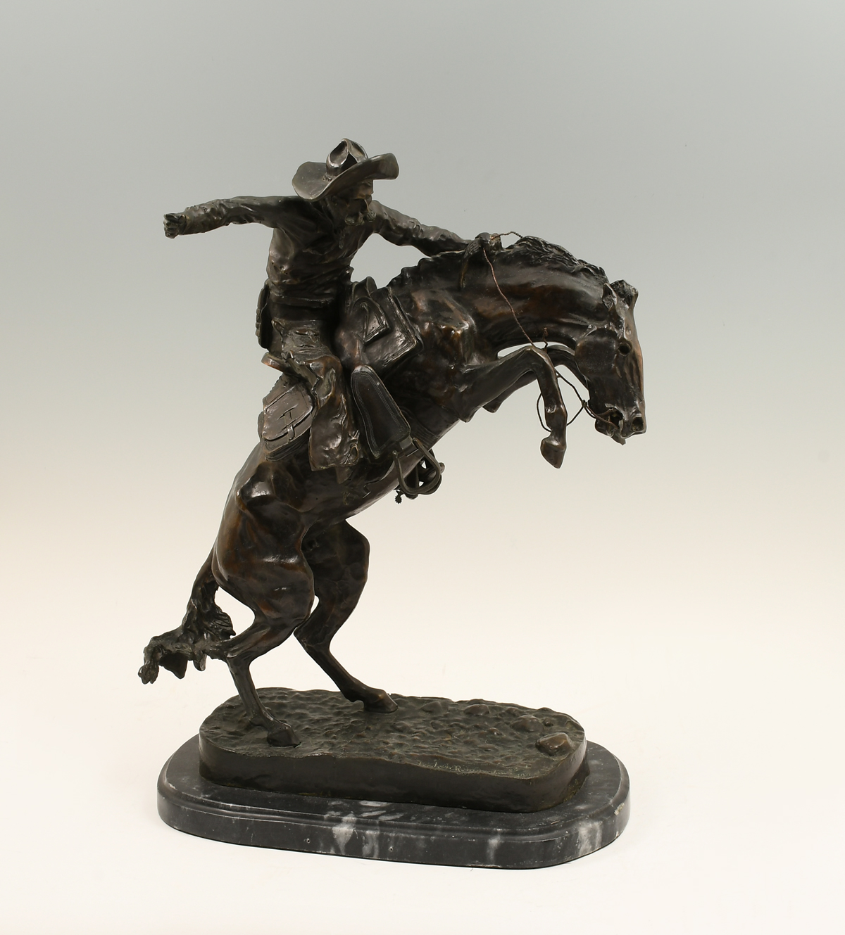 Appraisal: BRONZE BRONCO BUSTER SCULPTURE AFTER REMINGTON Affixed to marble plinth