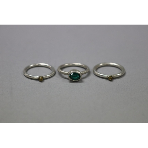 Appraisal: Three brushed sterling silver rings one with a green stone