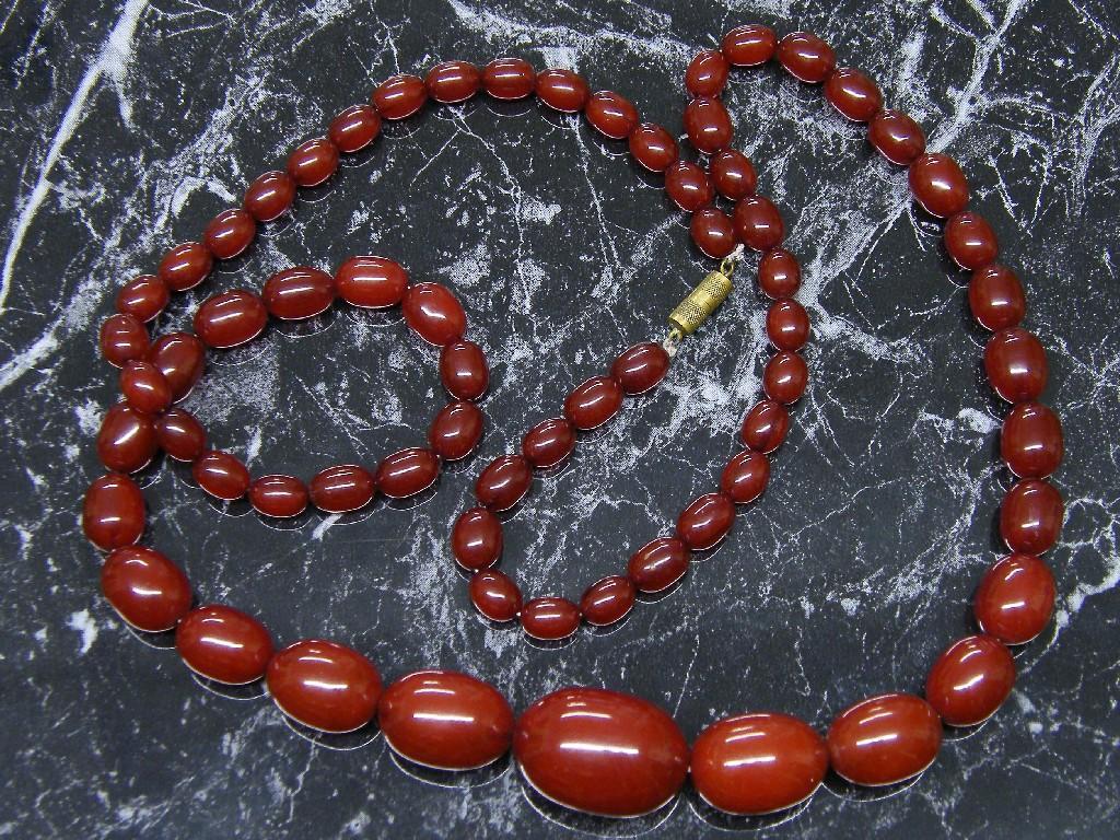 Appraisal: Phenolic resin red cherry oval graduated bead necklace with clasp