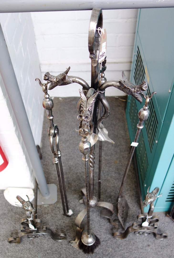 Appraisal: A set of steel fire irons on a stand with