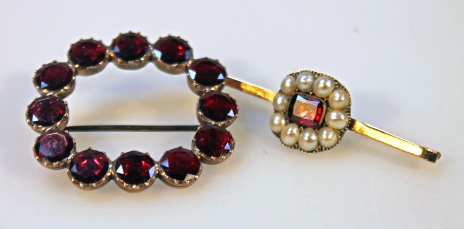 Appraisal: Two brooches comprising a garnet and seed pearl example the