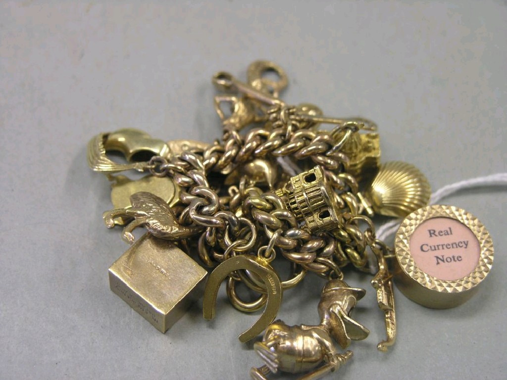 Appraisal: A ct gold charm bracelet with numerous ct gold charms