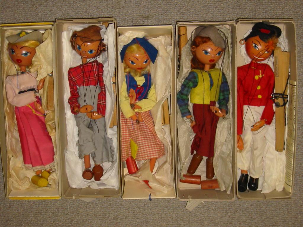 Appraisal: Five Pelham puppets comprising Mitzi in yellow snake charmer box