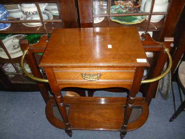 Appraisal: A LATE VICTORIAN WALNUT BRASS HALL STAND with central glove