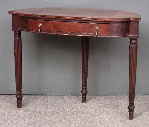 Appraisal: A mahogany bow and break-front side table of Georgian design