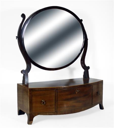 Appraisal: A George III mahogany dressing mirror of oval form with