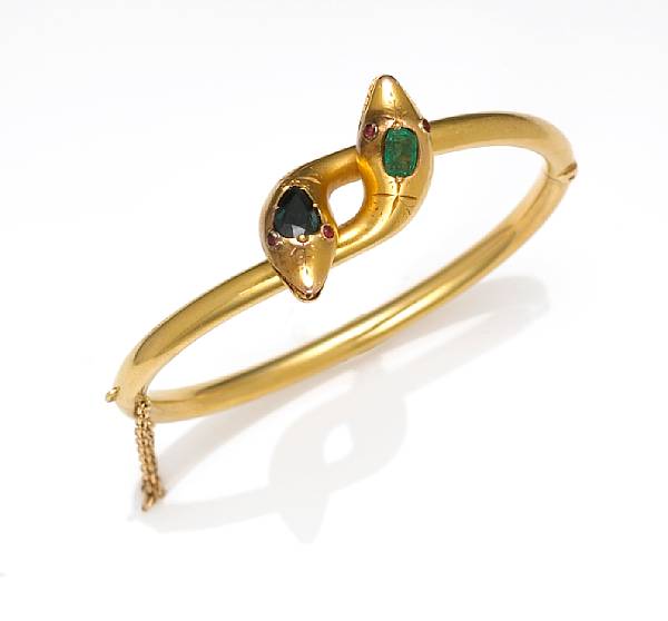 Appraisal: An emerald gem-stone and eighteen karat gold bangle bracelet of