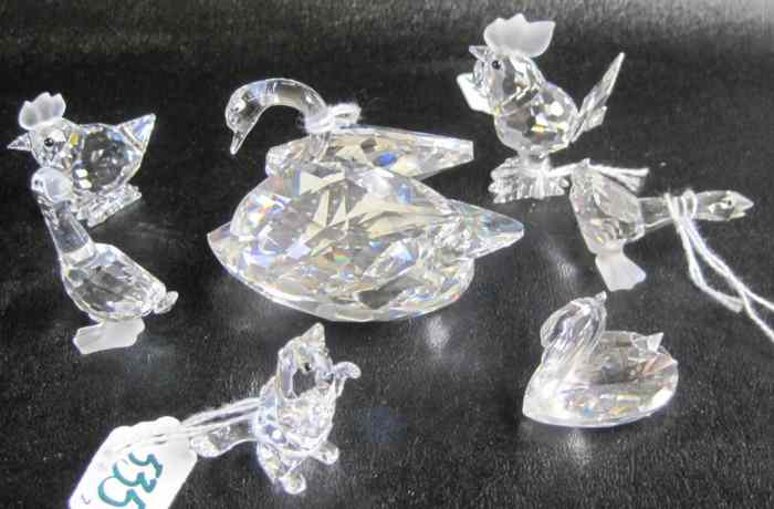 Appraisal: SEVEN SWAROVSKI CRYSTAL FIGURINES swan ''L smaller swan cat rooster