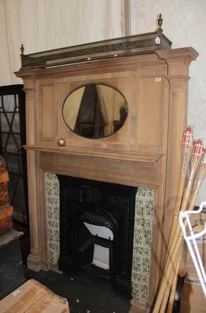 Appraisal: AN EDWARDIAN FIRE SURROUND with oval mirror above reeded pilaster